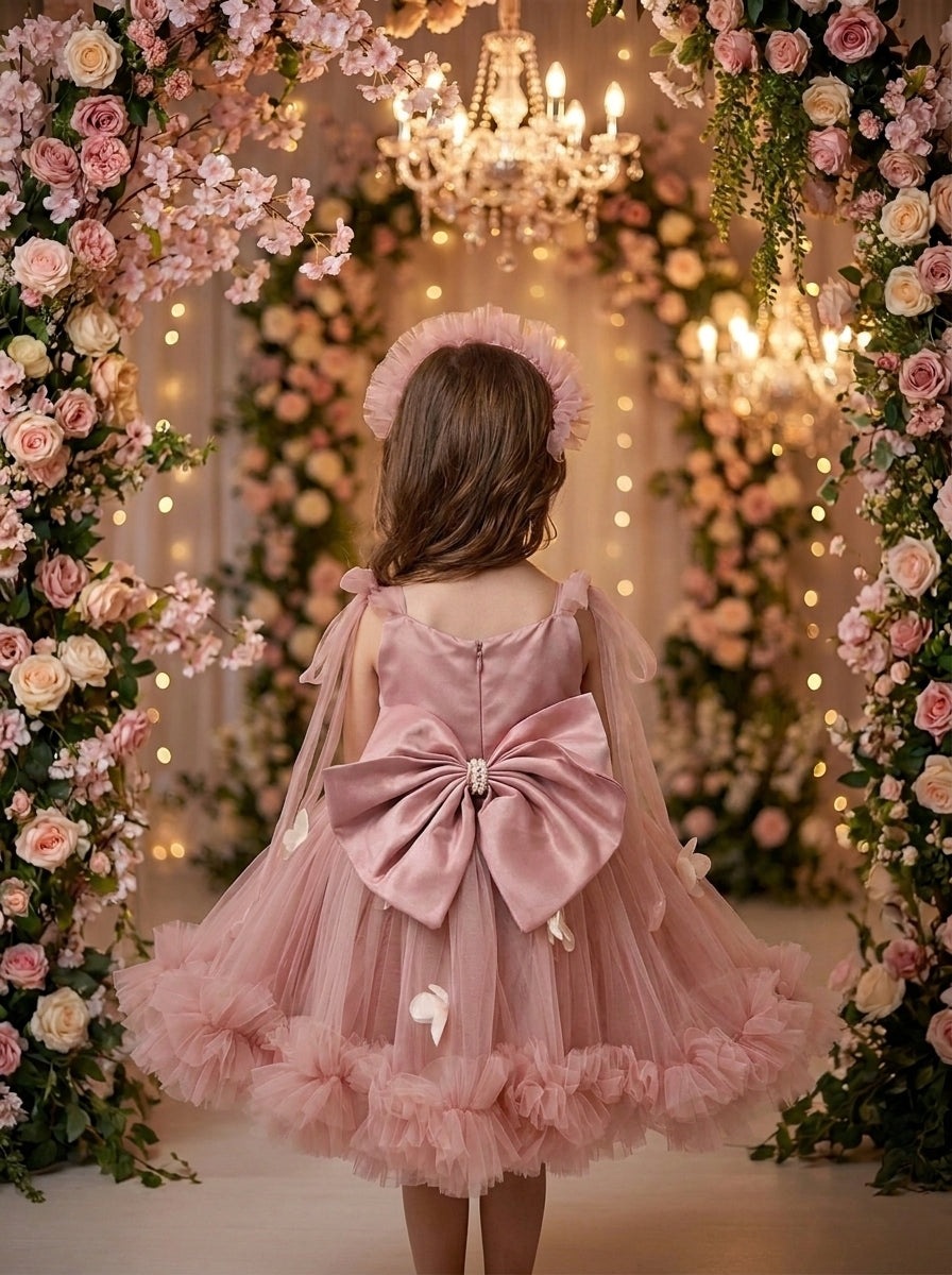Dusty Rose Petal Cascade Gown – dusty rose tulle dress with large back bow, back view on girl